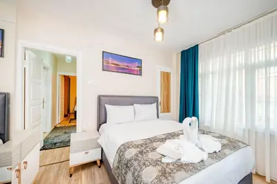 a bedroom with a bed with a stuffed animal on it at MARMARA DREAM APARt in Istanbul