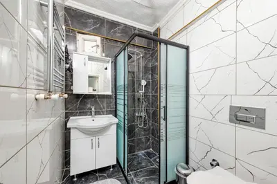 a bathroom with a shower and a sink and a toilet at MARMARA DREAM APARt in Istanbul