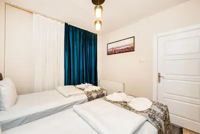 two beds in a room with a window at MARMARA DREAM APARt in Istanbul