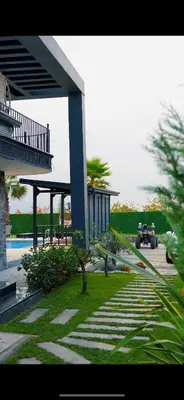 a house with a blue pillar and a yard at Parna Sapanca Hotel in Sakarya