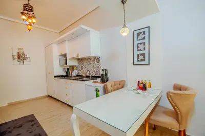 a kitchen with a table and a counter top at Taksim Nil Suite in Istanbul