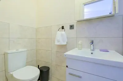 a bathroom with a white toilet and a sink at Casa Nozze in Istanbul