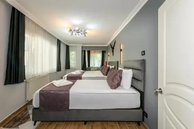 a bedroom with two beds and a window at Cenova Suite Hotel in Istanbul