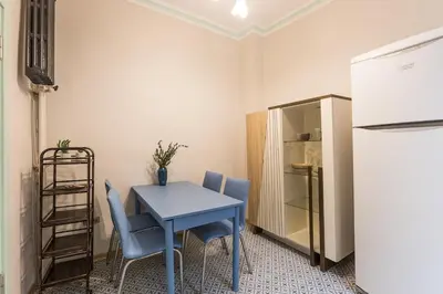 a kitchen with a blue table and chairs and a refrigerator at Stylish 1BR with Prime Location and Bold Design in Istanbul