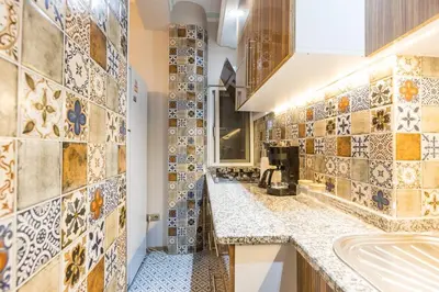 a bathroom with a sink and a tiled wall at Stylish 1BR with Prime Location and Bold Design in Istanbul