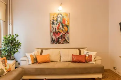 a couch in a living room with a painting on the wall at Stylish 1BR with Prime Location and Bold Design in Istanbul