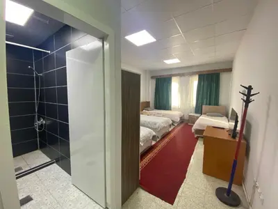 a hospital room with two beds and a bathroom at Kocaeli Konaklama in Izmit