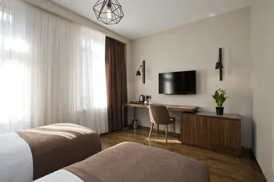 a hotel room with a bed and a desk and a tv at Snog Rooms & Suites in Istanbul