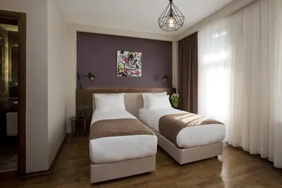 a bedroom with two beds and a window at Snog Rooms & Suites in Istanbul