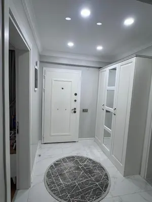 a hallway with a white door and a rug at Cadde Sapanca Sıcak Havuzlu Geniş Bahçeli in Sapanca