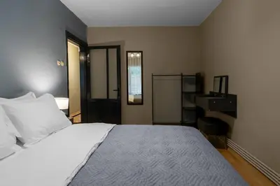 a bedroom with a white bed and a desk at Cozy and Modern 3BR with Private Patio in Beşiktaş in Istanbul