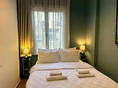 a bedroom with a bed with two towels on it at Elegant and Cozy 2BR with Balcony near Taksim in Istanbul
