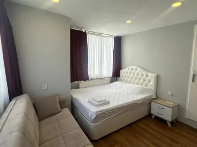 a small bedroom with a bed and a couch at Kaman Home Apart in Istanbul