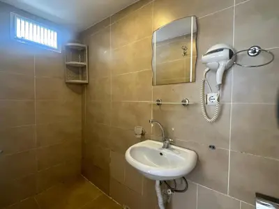 a bathroom with a sink and a phone on the wall at Kaman Home Apart in Istanbul