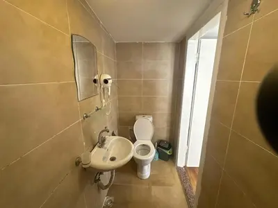 a small bathroom with a toilet and a sink at Kaman Home Apart in Istanbul