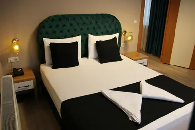 a bedroom with a large bed with a green headboard at Lina Suit Hotel in Istanbul