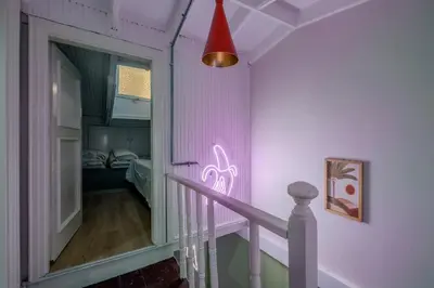 a staircase with a pink light on the wall at Cozy Private Home in Kadıköy – Near Coast Ferry in Istanbul