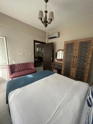a bedroom with a large bed and a red couch at Massa Home TAKSİM in Istanbul
