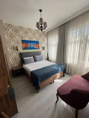 a bedroom with a bed and a chair in it at Massa Home TAKSİM in Istanbul