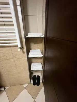 a bathroom with towels and shoes on the floor at Massa Home TAKSİM in Istanbul