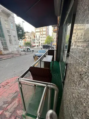 a balcony with two chairs and a table on a street at Massa Home TAKSİM in Istanbul