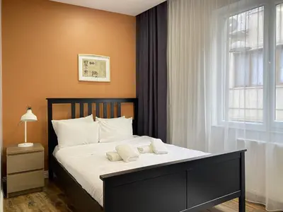 a bedroom with a bed with white pillows and a window at Central Comfortable Flat in Historic Balat in Istanbul