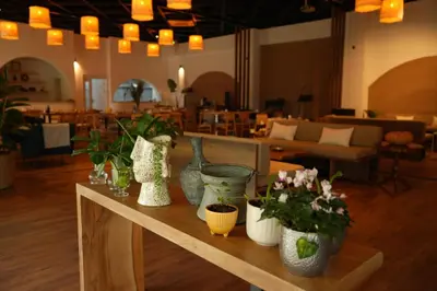 a table with vases and flowers on top of it at Cevizdibi Loft Villa in Kartepe