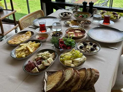 a table with many plates of food on it at Cevizdibi Loft Villa in Kartepe