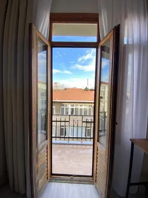 an open window with a view of a balcony at Bono Apartments Kadıköy in Istanbul