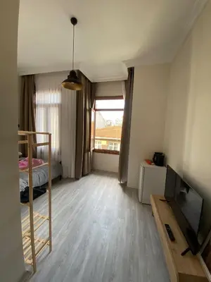 a small room with a bed and a television at Bono Apartments Kadıköy in Istanbul