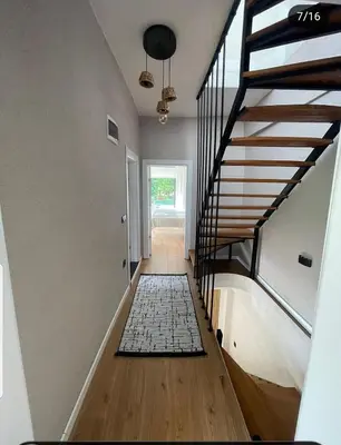 a hallway with a staircase with a rug on the floor at Fcvillasapanca in Sapanca