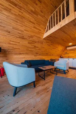 a living room with blue furniture and a wooden ceiling at Sapanca Sunday Bungalov Resort Otel in Sapanca