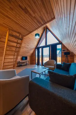 a living room with couches and a large window at Sapanca Sunday Bungalov Resort Otel in Sapanca