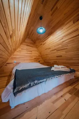 a bedroom with a bed in a wooden room at Sapanca Sunday Bungalov Resort Otel in Sapanca