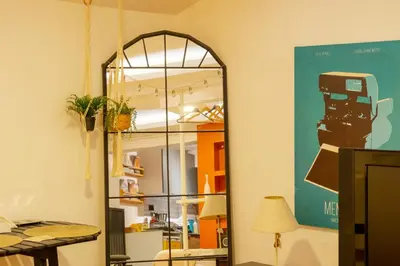a mirror in a room with a table and a lamp at Cosy Apartment in Beyoglu in Istanbul