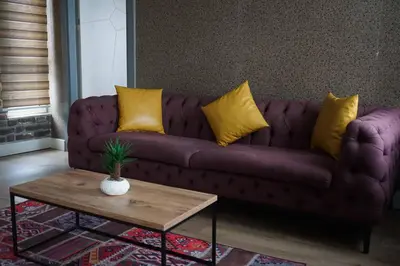 a living room with a purple couch with yellow pillows at SE Group Corner Suites in Istanbul