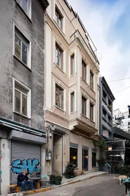 a man sitting on a bench in front of a building at Akçe 6 in Istanbul