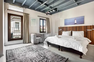 a bedroom with a large bed and a chair at Akçe 6 in Istanbul