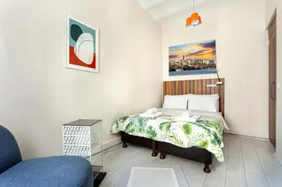a small bedroom with a bed and a chair at Akçe 6 in Istanbul