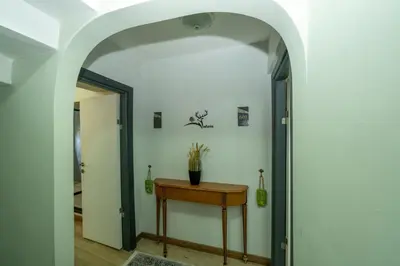 an archway leading into a hallway with a table and a door at Deluxe Valeria in Istanbul
