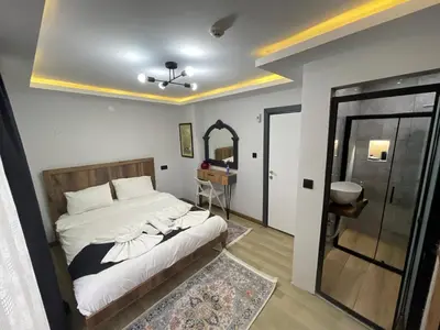 a bedroom with a bed and a mirror at Deluxe Valeria in Istanbul