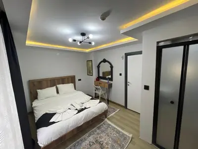 a bedroom with a bed and a mirror and a ceiling at Deluxe Valeria in Istanbul
