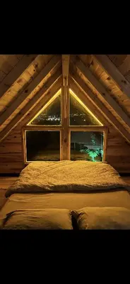 a bed in a room with a window at Galaxy Housing