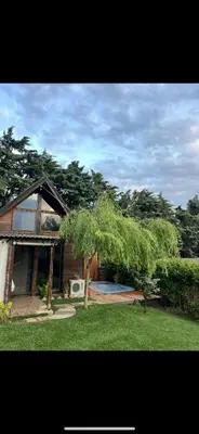 a house with a tree in the middle of a yard at Galaxy Housing