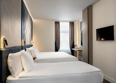 a hotel room with two beds and a television at Adamar Hotel-Special Category in Istanbul