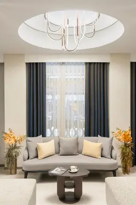 a living room with a couch and a chandelier at Adamar Hotel-Special Category in Istanbul