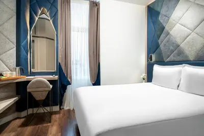 a hotel room with a bed and a mirror at Adamar Hotel-Special Category in Istanbul