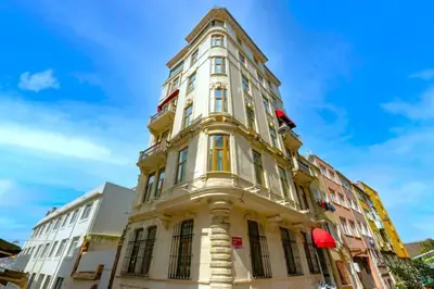 a tall yellow building with windows at Flex Pera in Istanbul