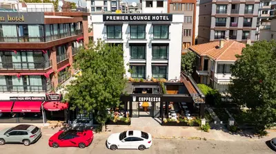 a group of cars parked in front of a building at Premier Lounge Hotel in Tuzla