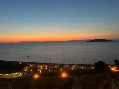 a view of a beach at night with the ocean at Ege Naz Villa in Avsa Adasi